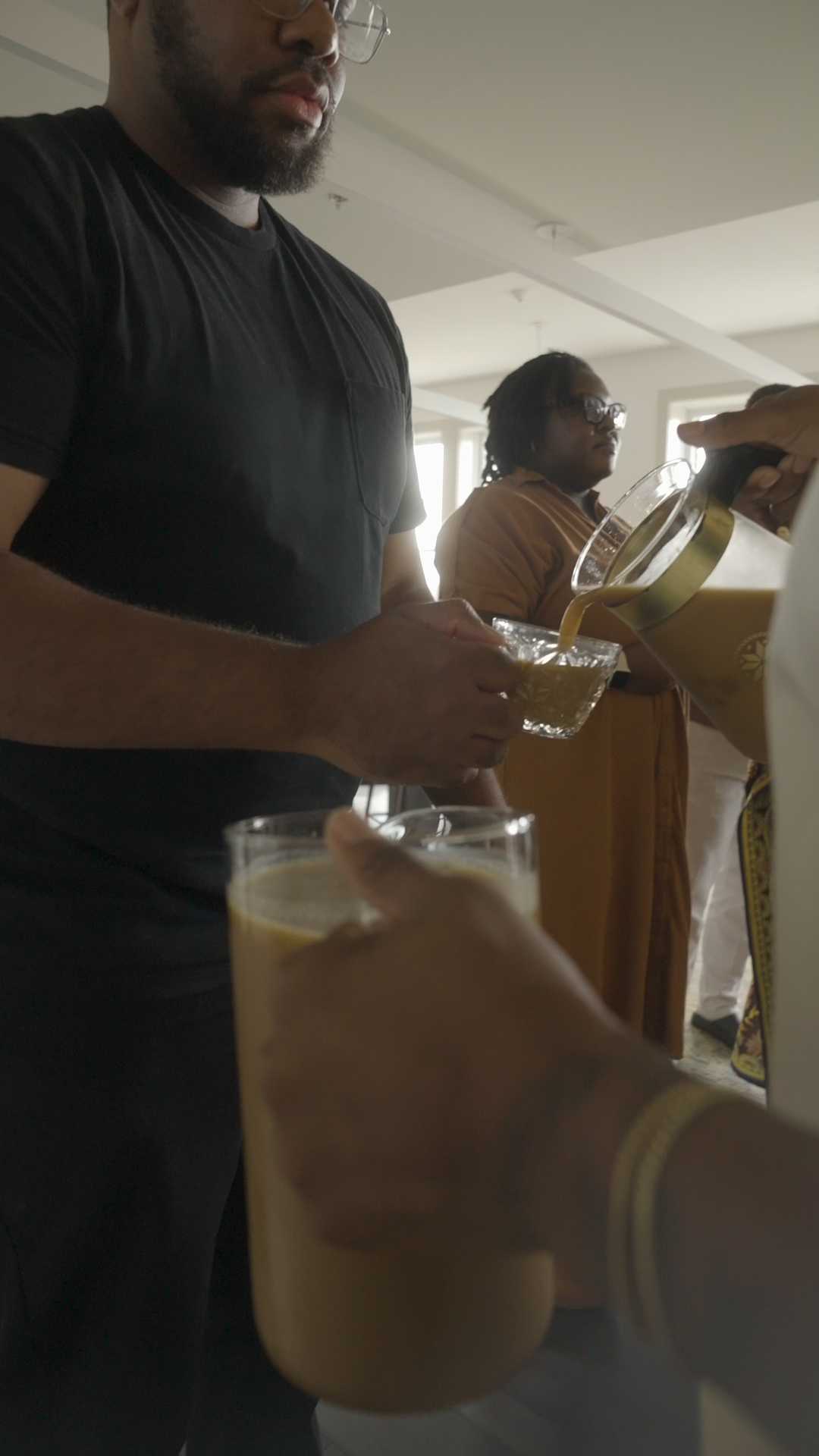 Coffee being poured into a guest's cup during the Illumination gathering.