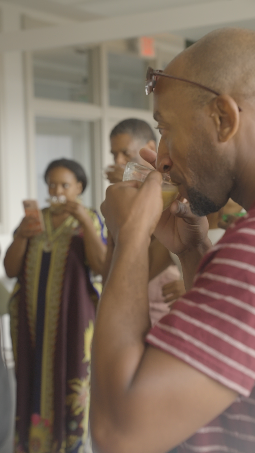 A guest drinking coffee at the Illumination gathering.